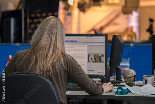 A journalist working on a computer in Newsroom photo