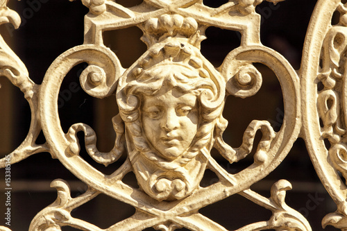 Detail of metal historic railing with girl face photo