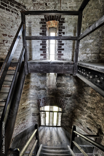 Interior of the old tower with wooden stairs photo