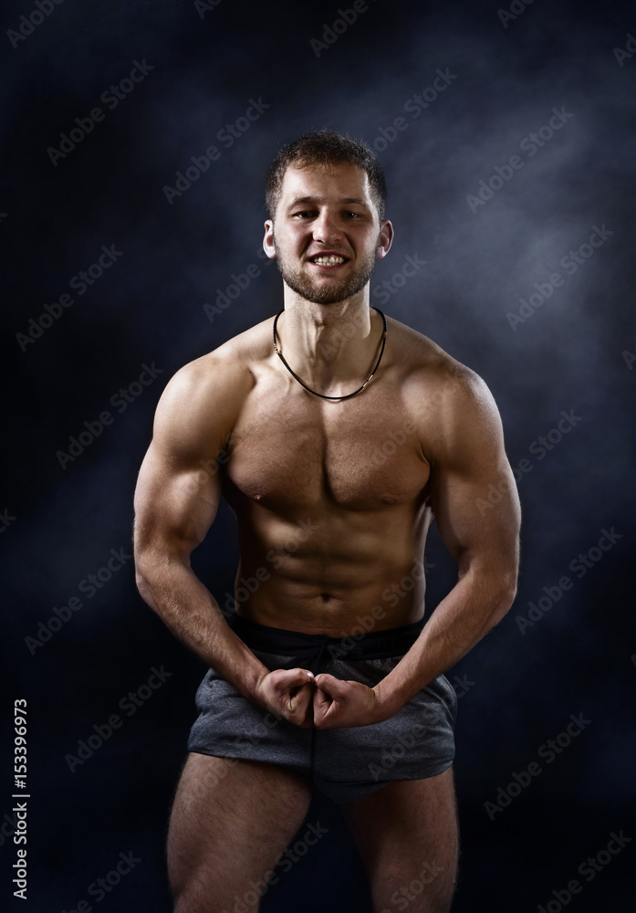 Young bodybuilder on a black background Young bodybuilder on a black background