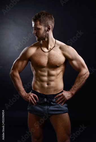 Young bodybuilder on a black background