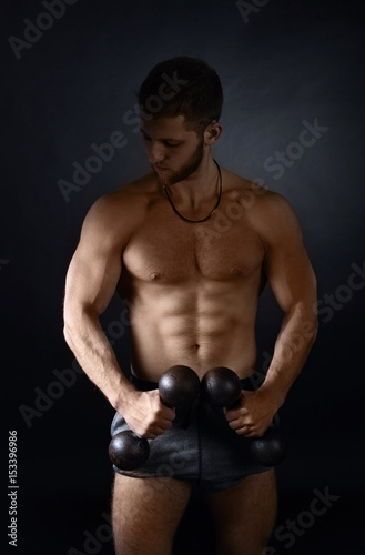 Young bodybuilder on a black background