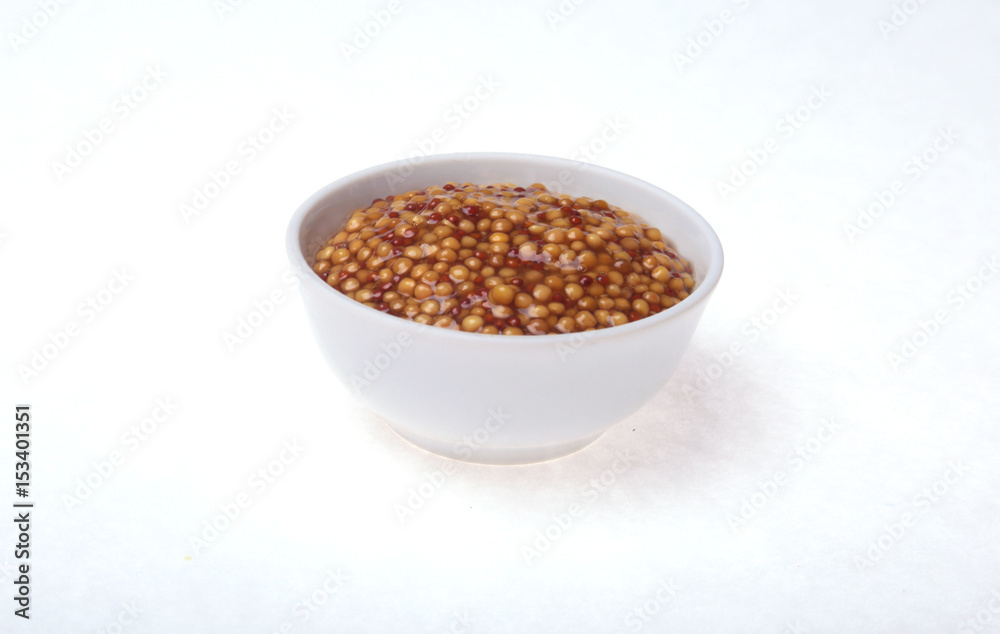 Typical french dijon rough mustard in bowl from isolated on white background Typical french dijon rough mustard in bowl from isolated on white background
