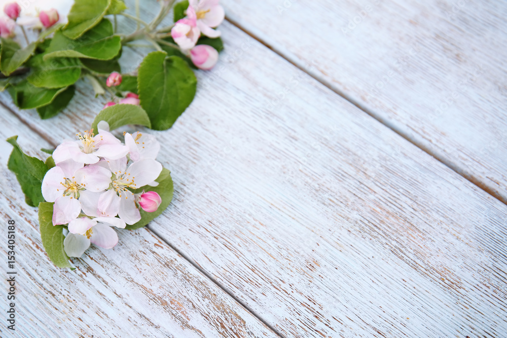 Tree branches with blooming flowers on wooden background Tree branches with blooming flowers on wooden background
