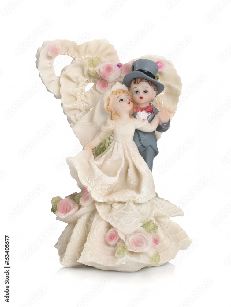 Fototapeta premium Bride and groom, old cake topper on white background