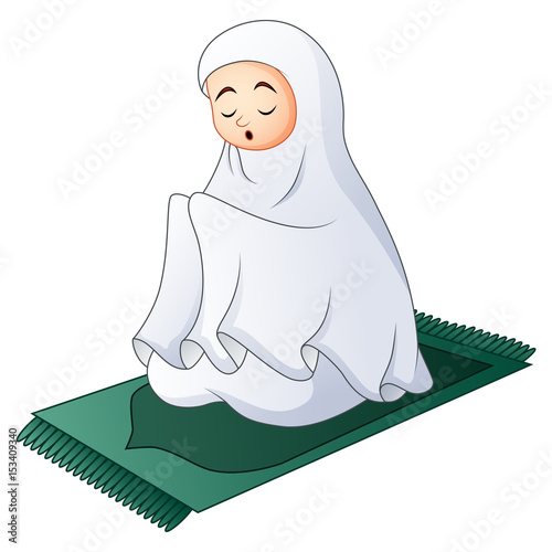 Muslim women sitting on the prayer rug while praying