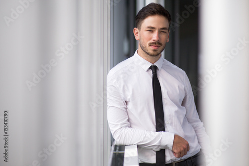 Tableau sur toile Serious young man resting in corridor