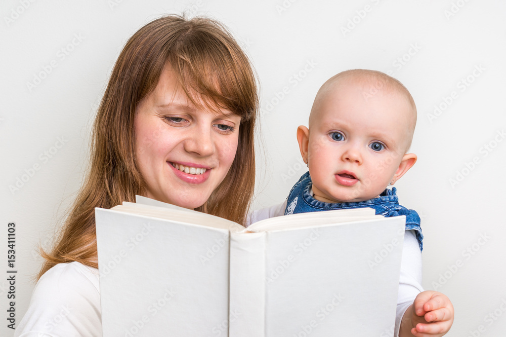 Smiling mother and her child reading a book Smiling mother and her child reading a book