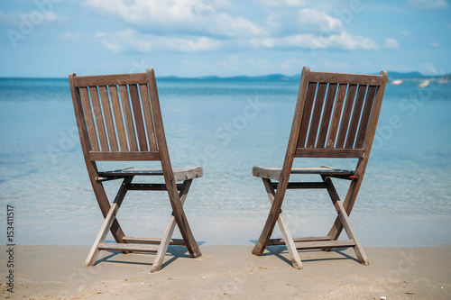 Two beach chairs on tropical shore