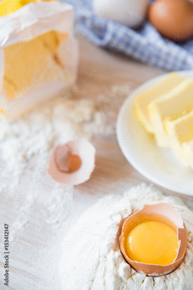 Eggs, flour, butter, pasta or baking ingredients on a wooden table . Selective focus Eggs, flour, butter, pasta or baking ingredients on a wooden table . Selective focus