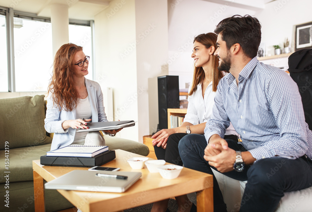 Female Real Estate agent offer home ownership and life insurance to young couple. Female Real Estate agent offer home ownership and life insurance to young couple.