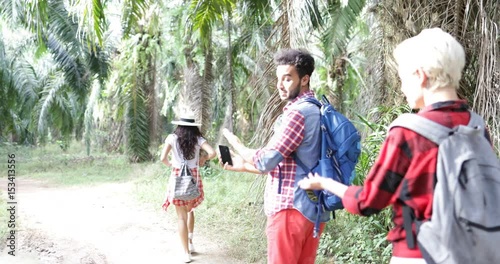 Wallpaper Mural People Group With Backpacks Get Lost Trekking On Forest Man Looking On Map On Smart Phone Tourists Hiking In Tropical Palm Tree Park Slow Motion 60 Torontodigital.ca