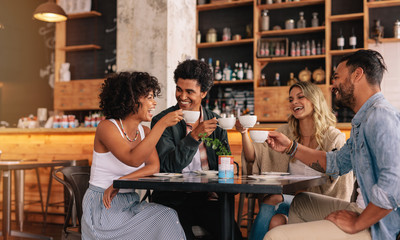 Group of friends at cafe having coffee together