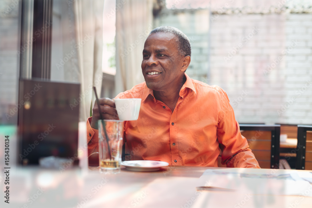 Businessman drinking espresso coffee in a cafe