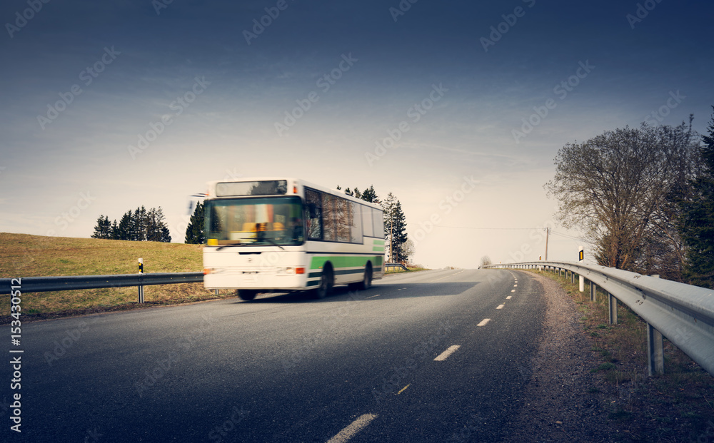 Bus on asphalt road in beautiful spring day at countryside Bus on asphalt road in beautiful spring day at countryside