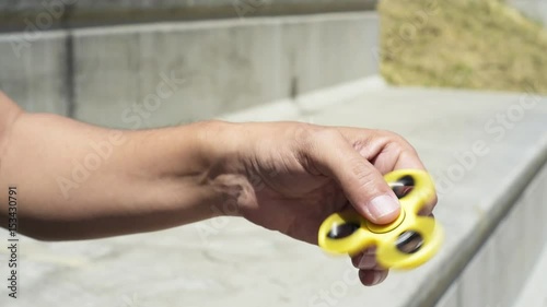 young man playing with a fidget spinner