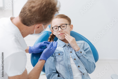 Sad young girl suffering from toothache