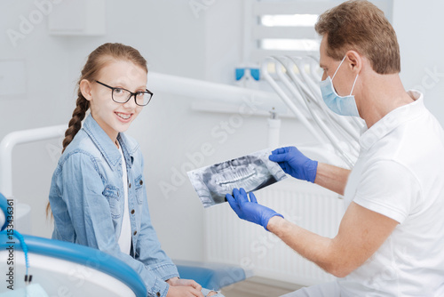 Bright teenage girl having an appointment with her dentist