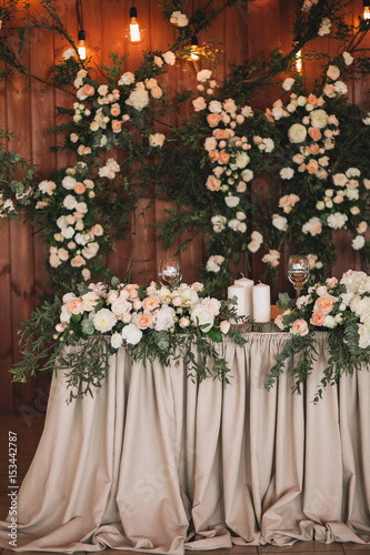 Wedding table banquet decorated with flowers and plants  retro lamps on a wooden background