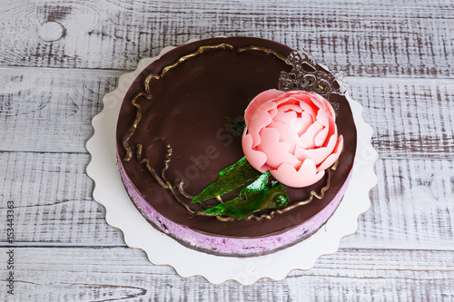 chocolate blueberry cheesecake with chocolate peony and isomalt decoration photo