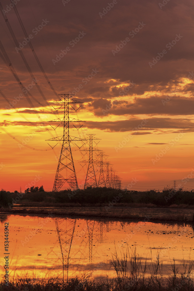 Silhouette high voltage power lines at sunset  in Thailand