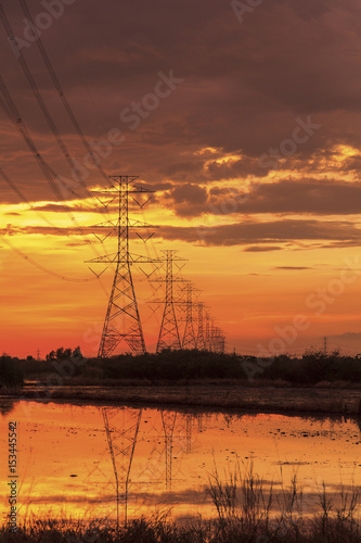 Silhouette high voltage power lines at sunset in Thailand