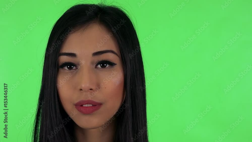 young attractive asian woman looks to camera (serious face) - green screen young attractive asian woman looks to camera (serious face) - green screen