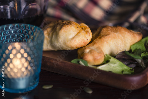 Two lamb stuffed empanadas and a glass of red local wine in a patagonia argentina chic retreat.