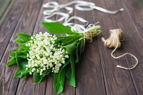 Lily-of-the-valley flowers bouquet on wooden table