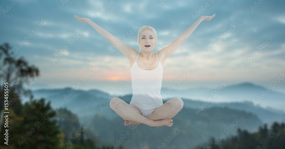 Double exposure of woman performing yoga in midair against mountains Double exposure of woman performing yoga in midair against mountains