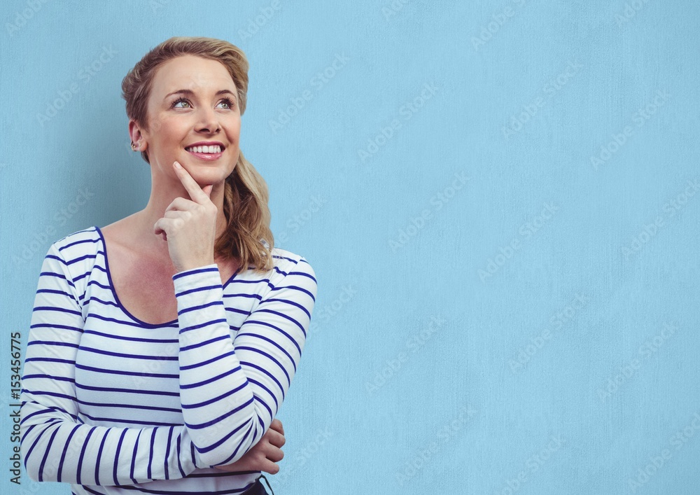 Obraz premium woman with hand on chin looking away over blue background