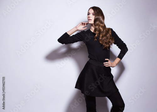 Beautiful elegant woman posing on grey background