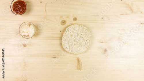 Making burger and chips on wooden background - top view