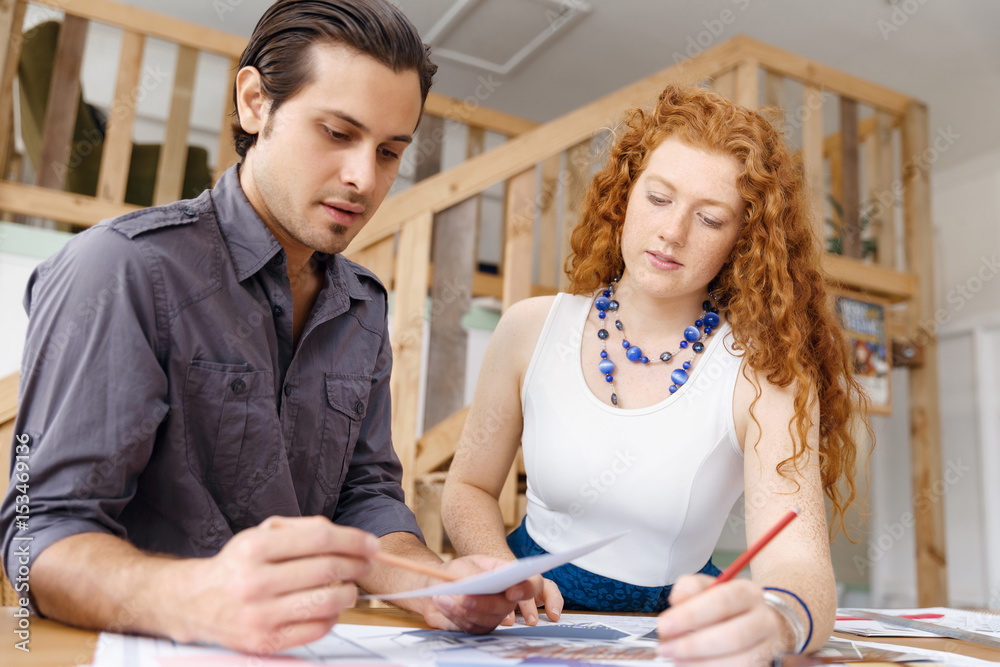 Obraz premium Two young architects in office