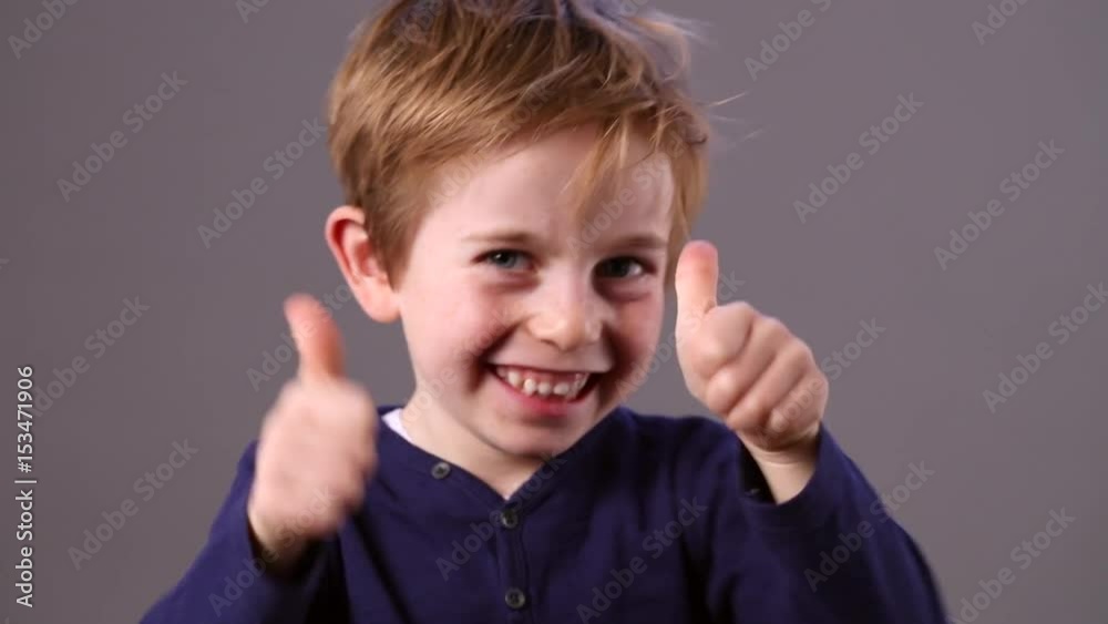 cheerful young preschool red hair child showing his satisfaction cheerful young preschool red hair child showing his satisfaction