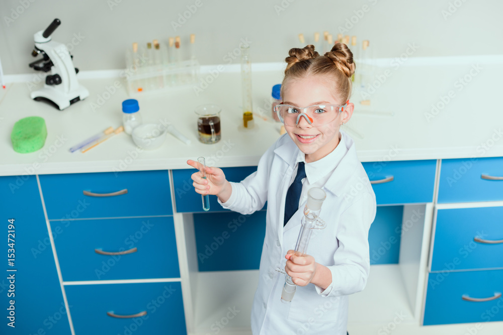 schoolgirl in goggles holding reagents in flasks in chemical lab, science student concept schoolgirl in goggles holding reagents in flasks in chemical lab, science student concept