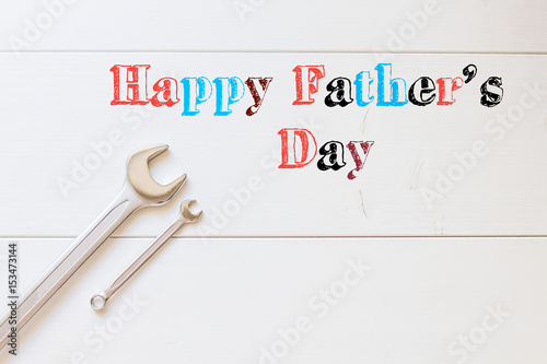 Happy Fathers day, tools with cable on white wooden background, best dad ever © Adamchuk