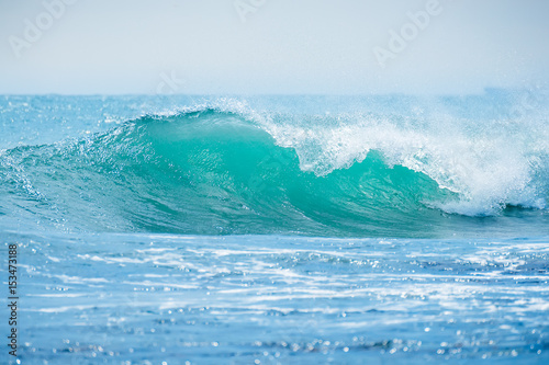 Blue wave in tropical ocean. Wave crashing in sunny day © artifirsov