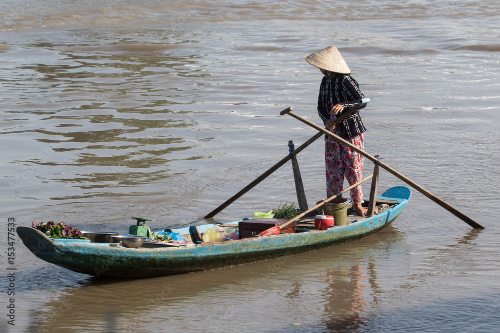 Vietnamese woman on a  wooden boat