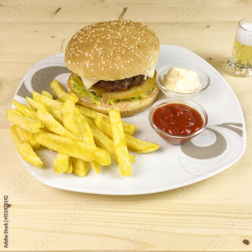 Burger and chips on wooden background