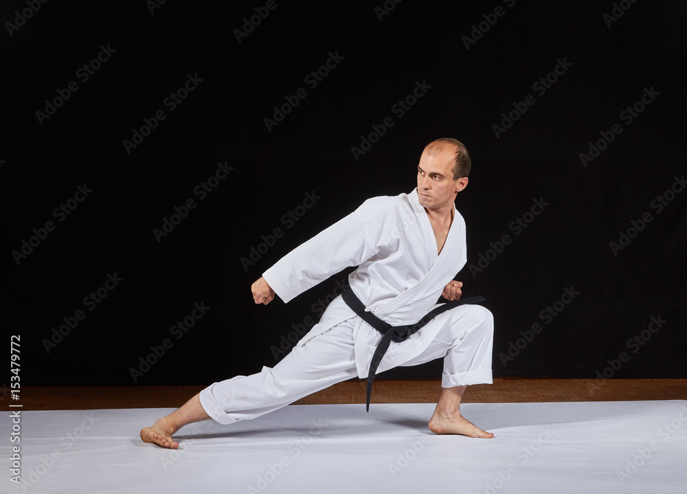 An athlete makes a block with his hand in a low karate rack Kaderov