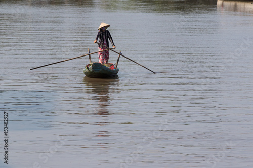 Vietnamese woman on a wooden boat