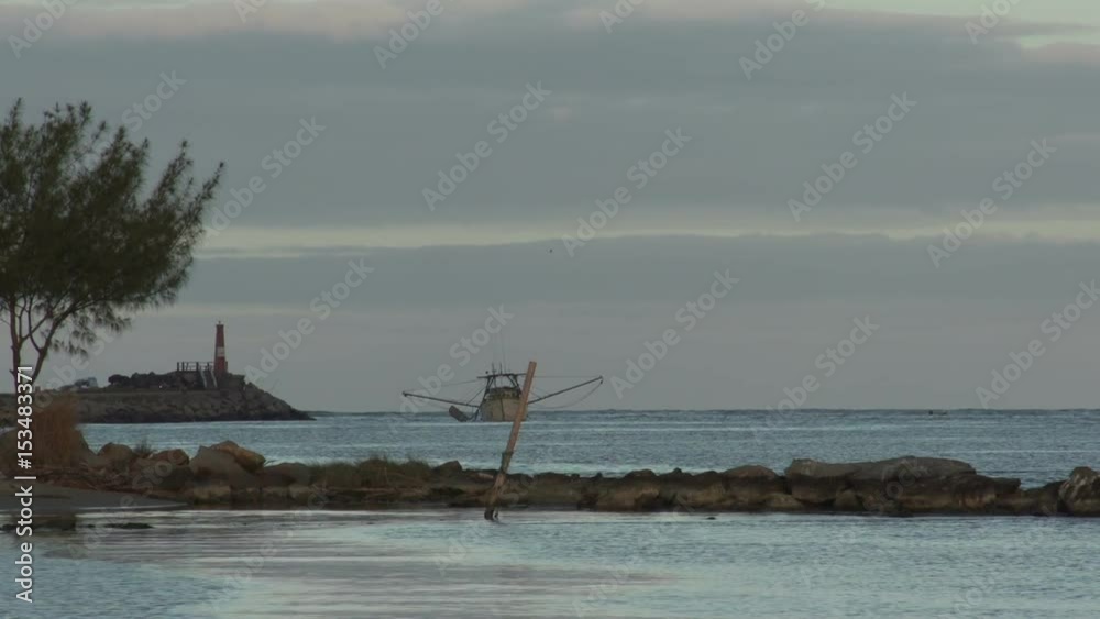 Fishingboat on lake at sunset, lighthouse, Laguna, Santa Catarina Fishingboat on lake at sunset, lighthouse, Laguna, Santa Catarina