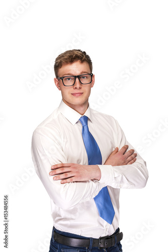 Business Man with crossed arms and blue tie isolated over white background.