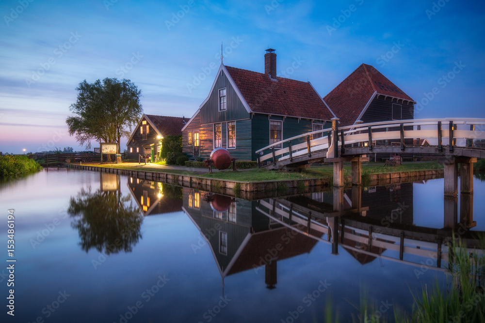 Typical Dutch farm reflected in the canal, Zaanse Schans near Amsterdam Typical Dutch farm reflected in the canal, Zaanse Schans near Amsterdam