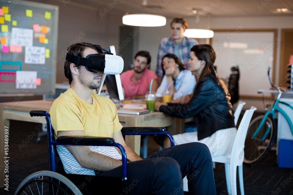 Naklejka premium Physically disabled man on wheelchair using VR headset