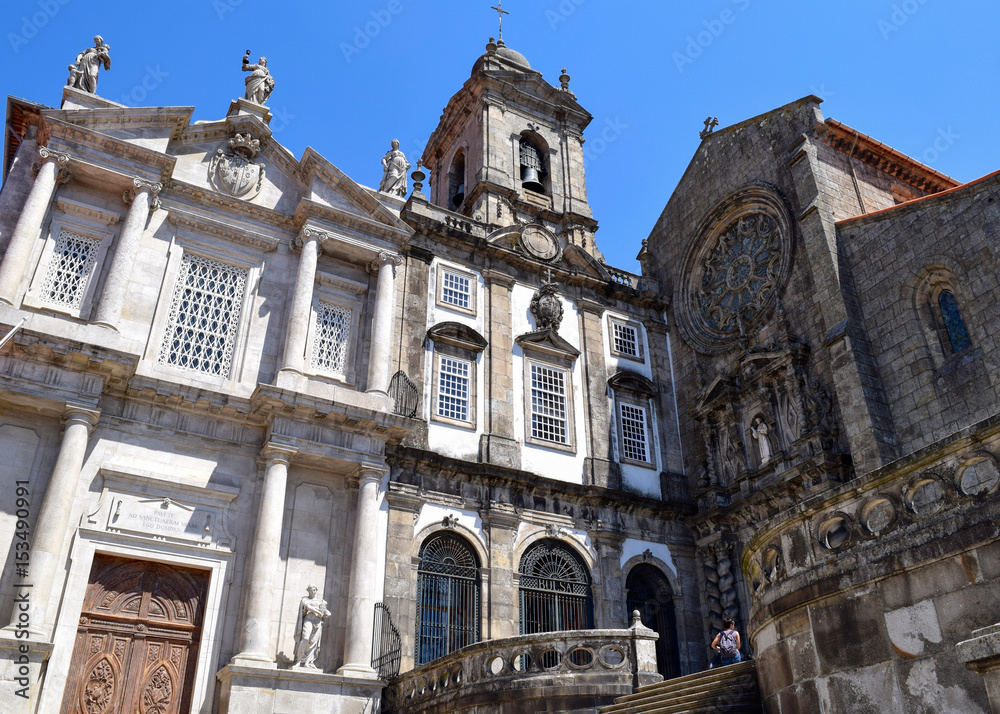 Unidentified people stand outside the gothic Igreja Monumento de Sao Francisco Church of Porto, Portugal