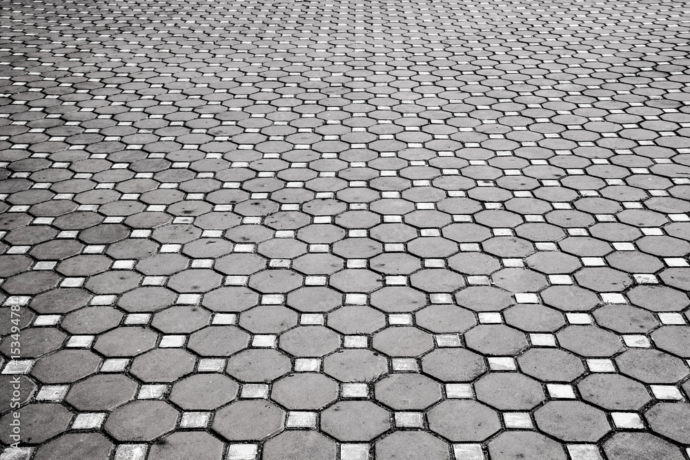 Cement brick floor background,patterned paving tiles.Brick paving stones on a sidewalk,black and white tone