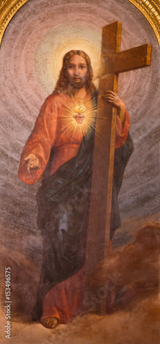 Quadro su tela TURIN, ITALY - MARCH 15, 2017: The painting of Sacred Heart of Reserrected Jesus with the cross in church Basilica Maria Ausiliatrice by Carlo Morgari (1939)