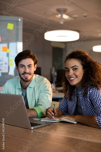 Creative business people working on desk at office